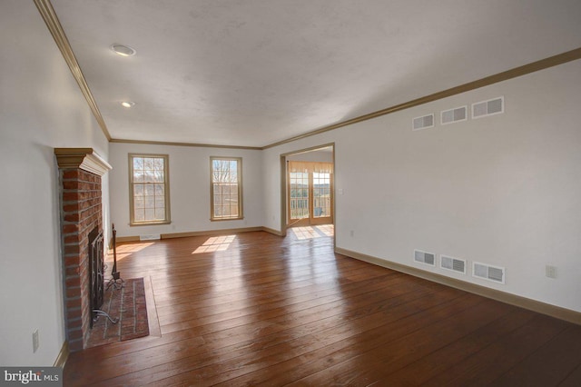 unfurnished living room with hardwood / wood-style floors, a brick fireplace, baseboards, and ornamental molding