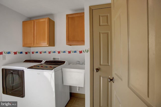 washroom with tile patterned flooring, separate washer and dryer, cabinet space, and a sink