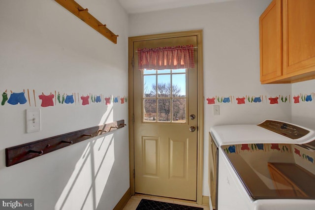 doorway featuring washing machine and dryer and light tile patterned flooring