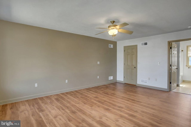 interior space with light wood-style floors, visible vents, and baseboards