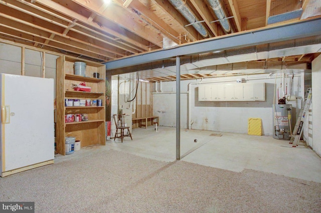 unfinished basement with water heater and freestanding refrigerator