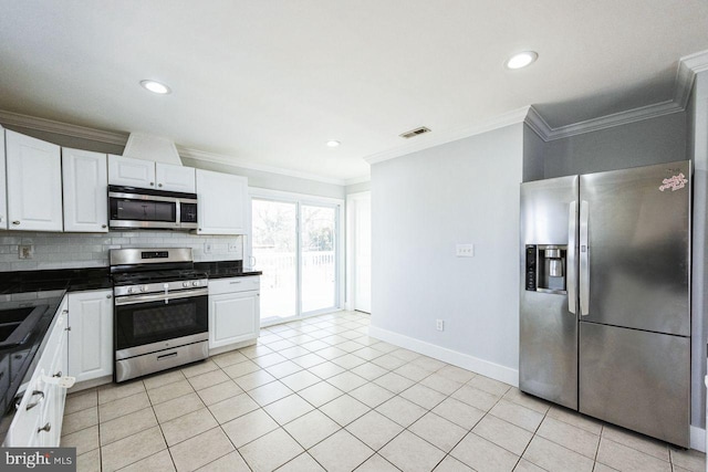 kitchen with light tile patterned floors, visible vents, stainless steel appliances, dark countertops, and tasteful backsplash