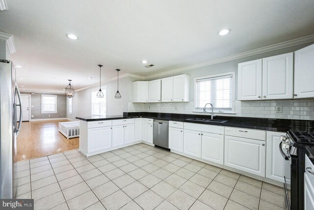 kitchen featuring a sink, appliances with stainless steel finishes, open floor plan, and a healthy amount of sunlight