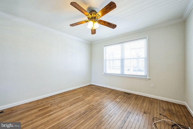 spare room featuring baseboards, light wood-style flooring, a ceiling fan, and ornamental molding