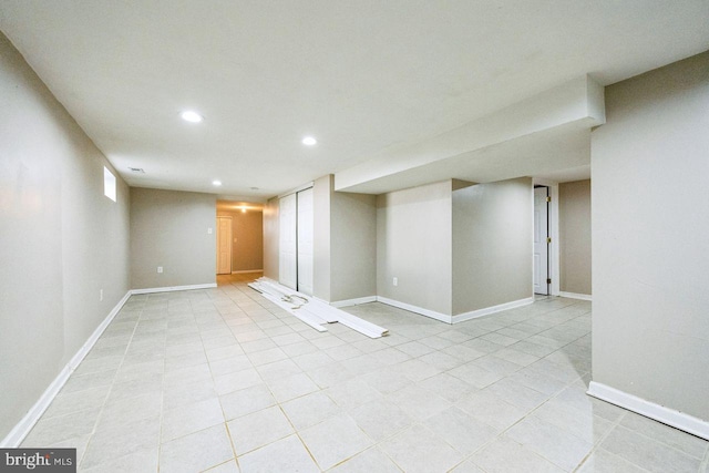 finished basement featuring recessed lighting, baseboards, and light tile patterned floors