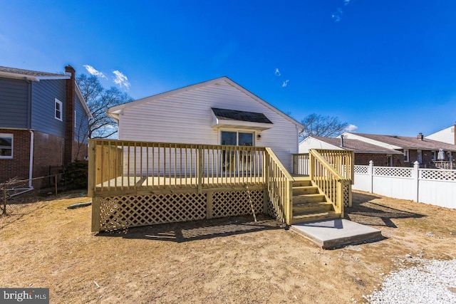 back of house featuring a wooden deck and fence