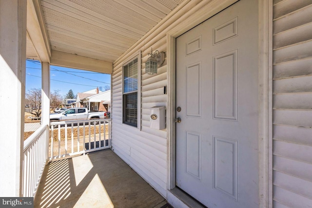 entrance to property featuring a porch