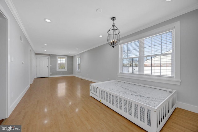 interior space with baseboards, a chandelier, ornamental molding, recessed lighting, and wood finished floors