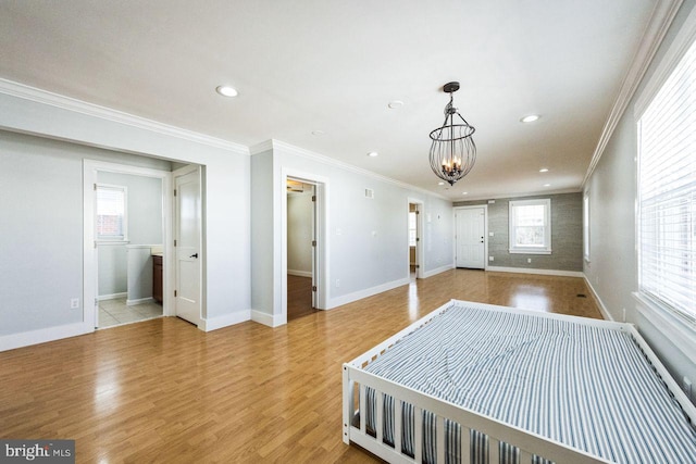 bedroom with a notable chandelier, recessed lighting, light wood-type flooring, and ornamental molding