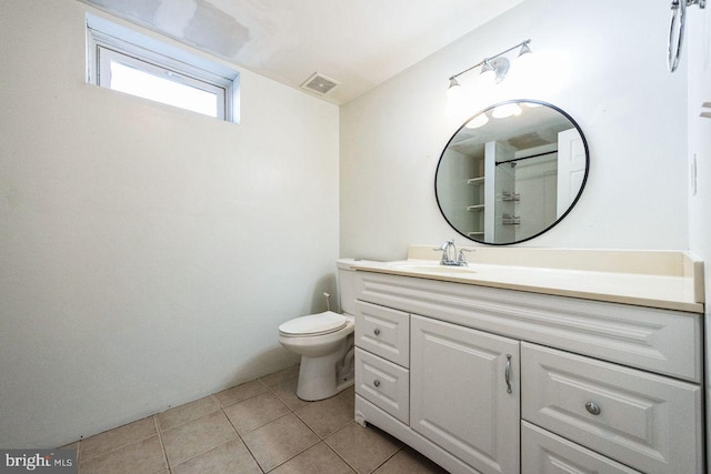 bathroom featuring visible vents, toilet, vanity, and tile patterned flooring