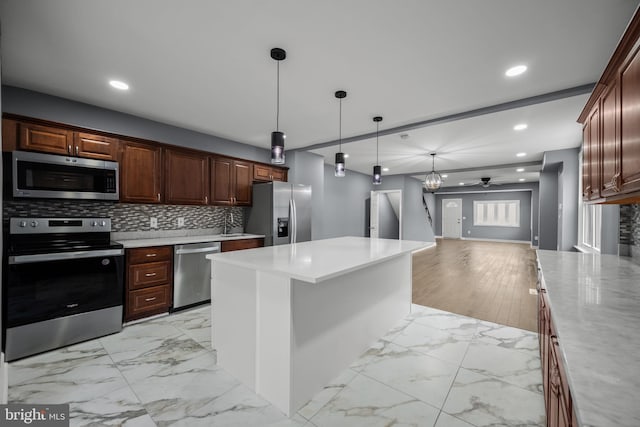 kitchen with marble finish floor, recessed lighting, decorative backsplash, appliances with stainless steel finishes, and a ceiling fan