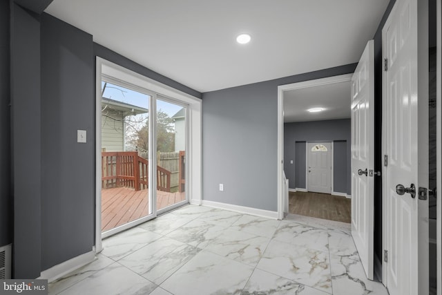 spare room featuring marble finish floor, visible vents, and baseboards