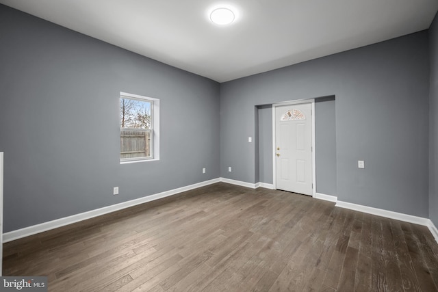 empty room featuring baseboards and wood finished floors