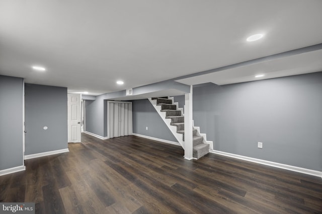 finished basement featuring stairs, baseboards, wood finished floors, and recessed lighting