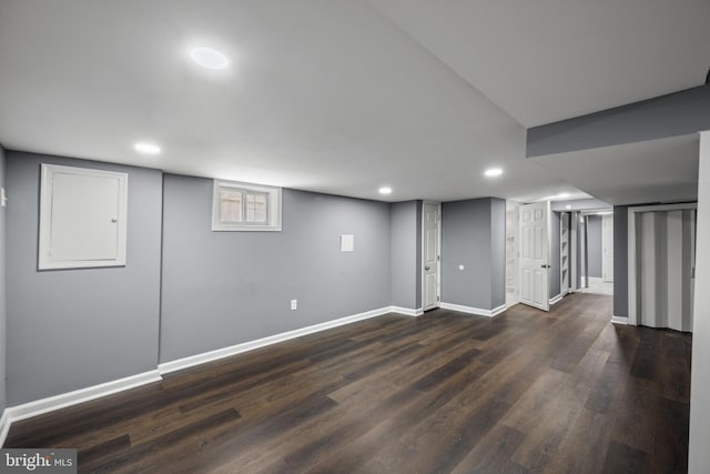 basement featuring dark wood-type flooring, recessed lighting, and baseboards