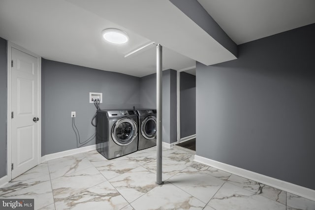 laundry area with laundry area, marble finish floor, and baseboards