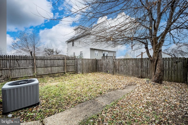 view of yard featuring central AC and a fenced backyard