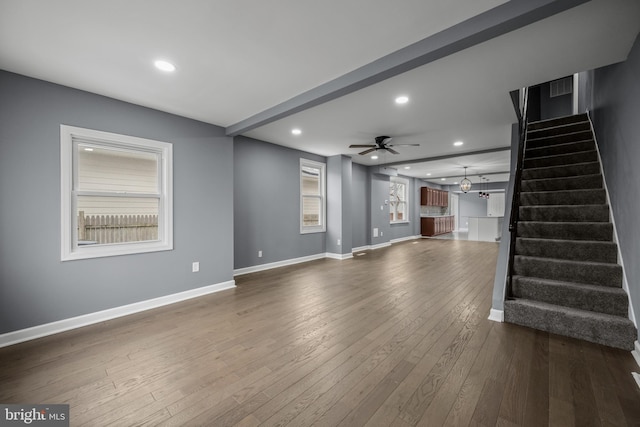 unfurnished living room featuring baseboards, stairway, dark wood finished floors, and recessed lighting