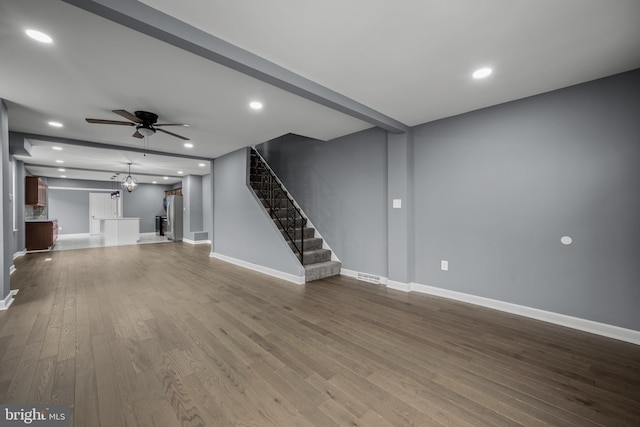 unfurnished living room featuring recessed lighting, ceiling fan, stairway, and wood finished floors