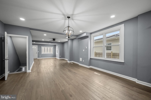 unfurnished living room with dark wood-style floors, recessed lighting, and baseboards