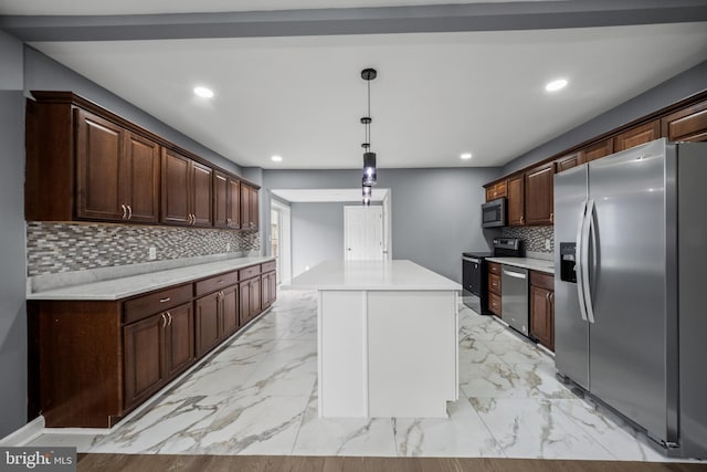 kitchen featuring a center island, marble finish floor, recessed lighting, light countertops, and appliances with stainless steel finishes