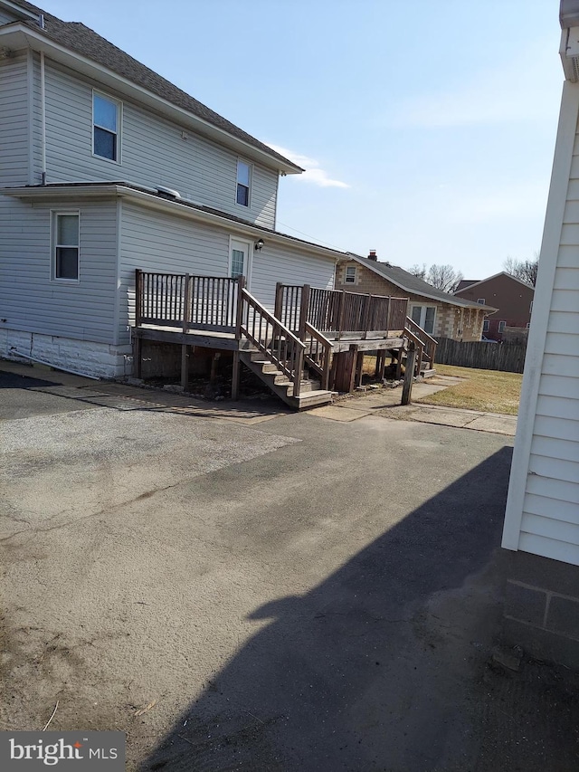 rear view of property featuring a deck