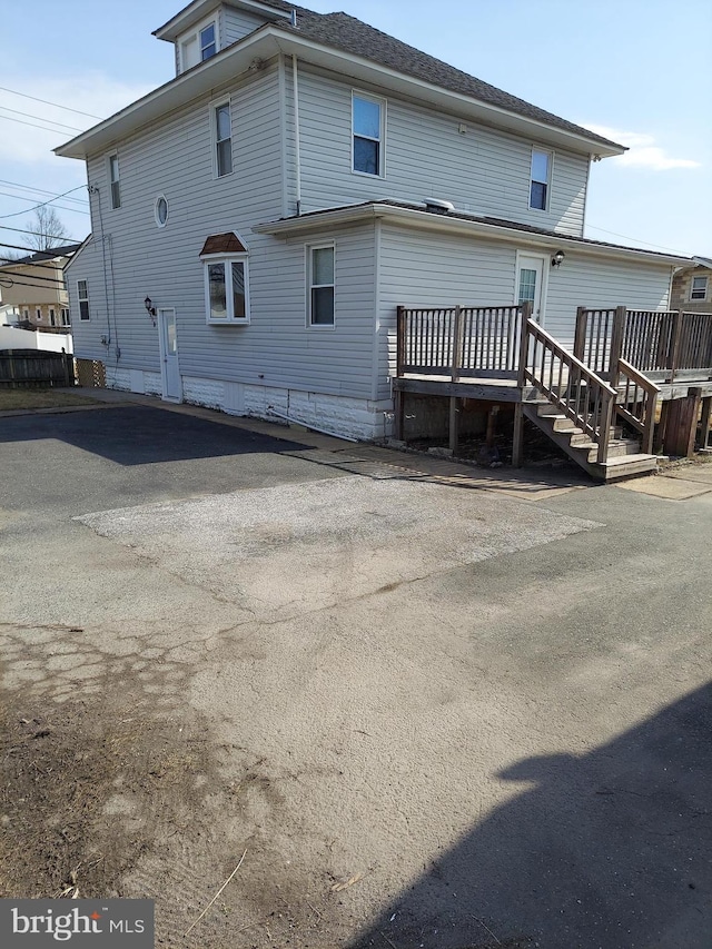 rear view of house with a wooden deck