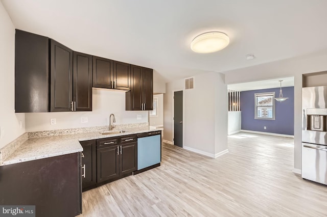 kitchen featuring dark brown cabinetry, dishwasher, stainless steel fridge with ice dispenser, light wood-style floors, and a sink