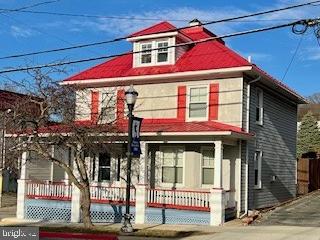 american foursquare style home with covered porch