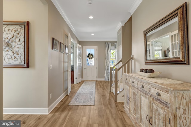 foyer entrance with crown molding, recessed lighting, light wood finished floors, and baseboards