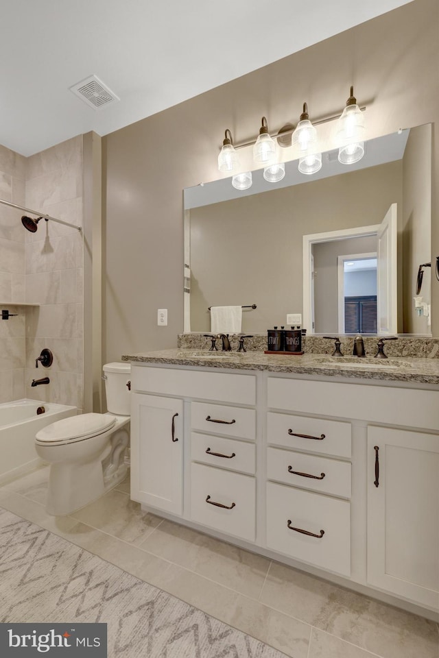 bathroom with a sink, double vanity, toilet, bathing tub / shower combination, and visible vents