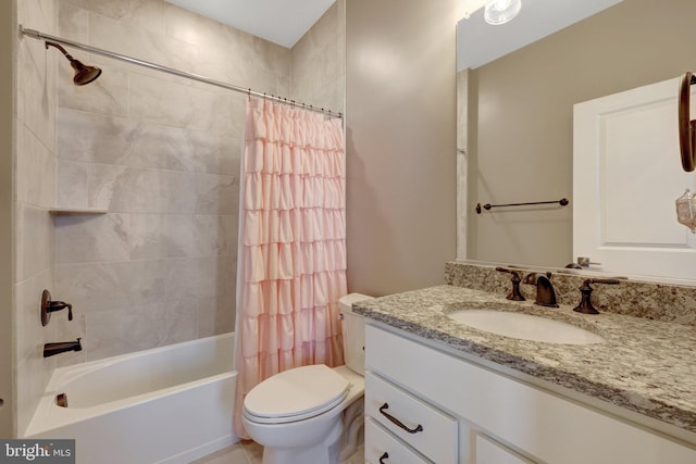 bathroom featuring vanity, toilet, tile patterned flooring, and shower / bath combo with shower curtain