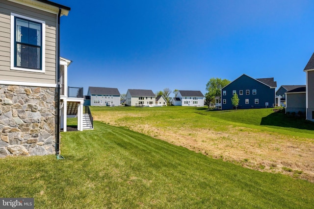 view of yard with a residential view and stairs