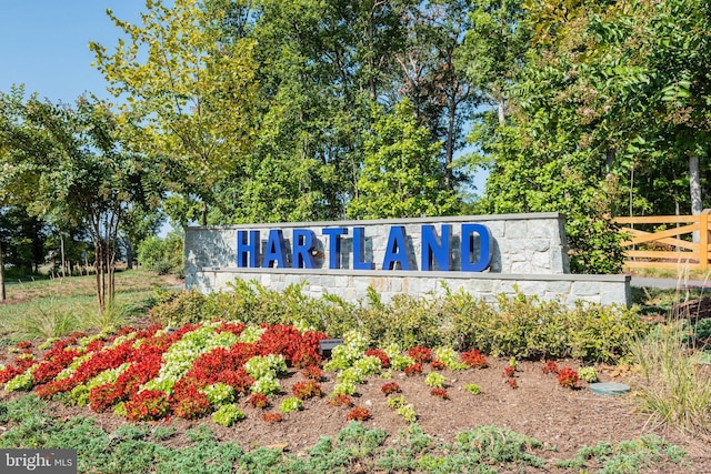 community / neighborhood sign with fence