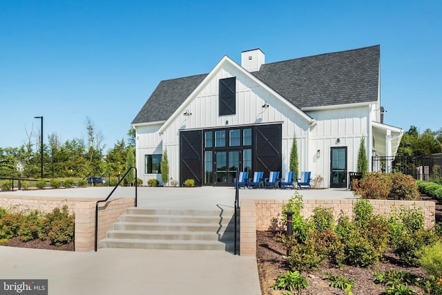 exterior space featuring a barn and fence