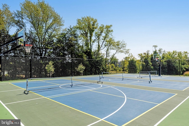 view of basketball court with fence, community basketball court, and a tennis court
