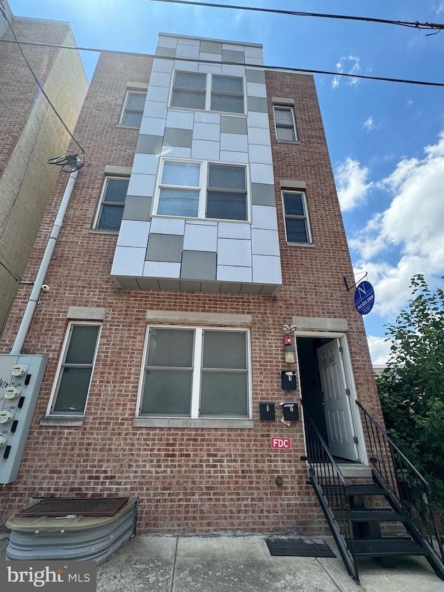 townhome / multi-family property featuring brick siding