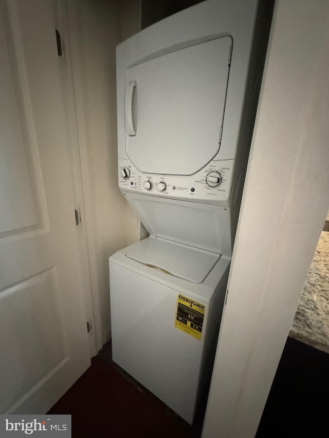 laundry room featuring stacked washer and dryer and laundry area