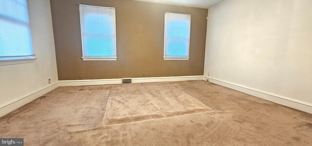 carpeted spare room with visible vents