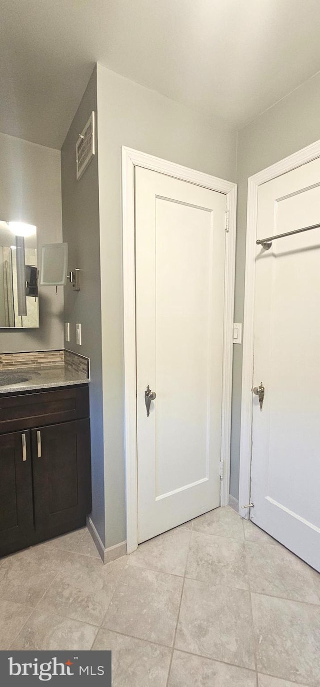 bathroom featuring vanity and baseboards