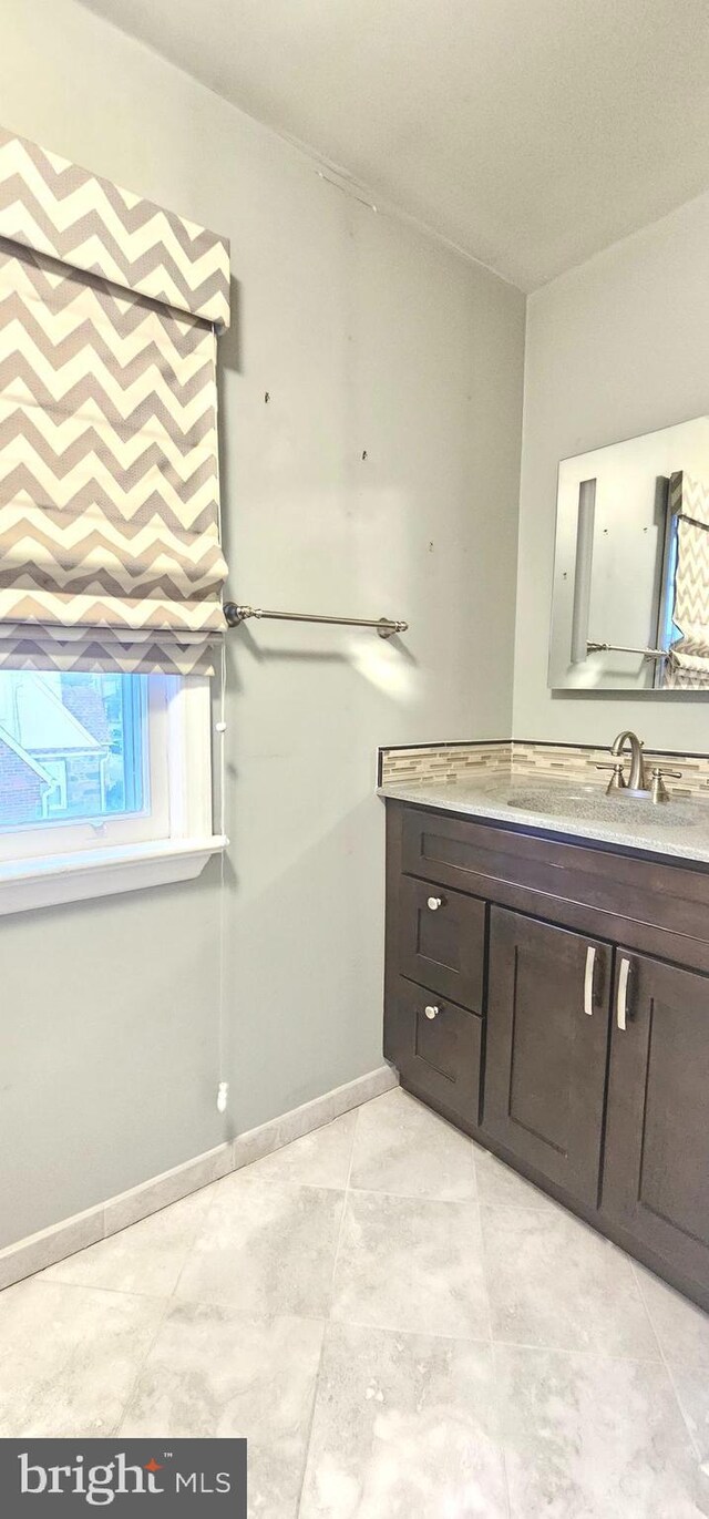 bathroom with baseboards and vanity