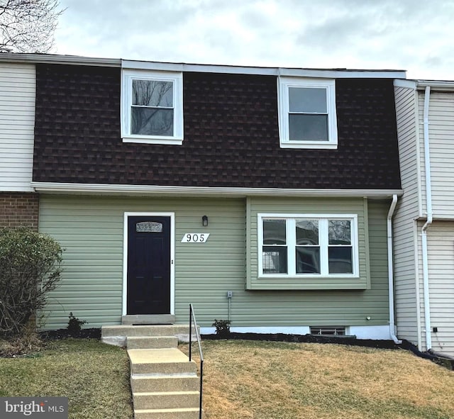 multi unit property featuring a shingled roof, entry steps, a front lawn, and mansard roof