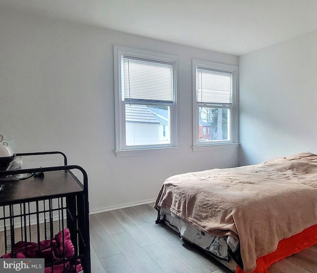 bedroom with wood finished floors and baseboards