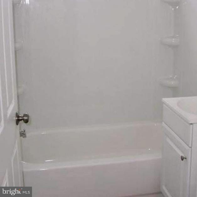 full bath featuring vanity and washtub / shower combination