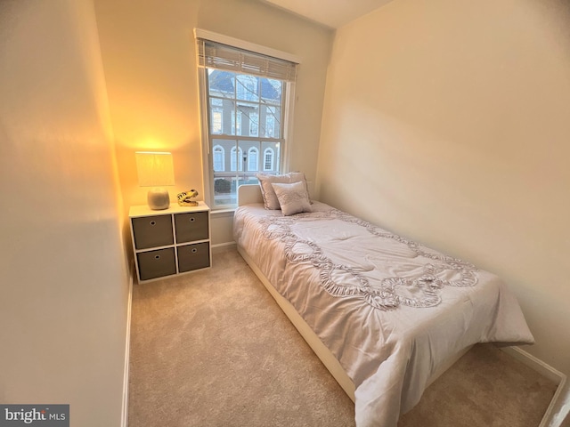 carpeted bedroom featuring baseboards