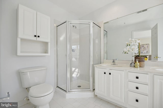 bathroom with a shower stall, toilet, double vanity, and a sink