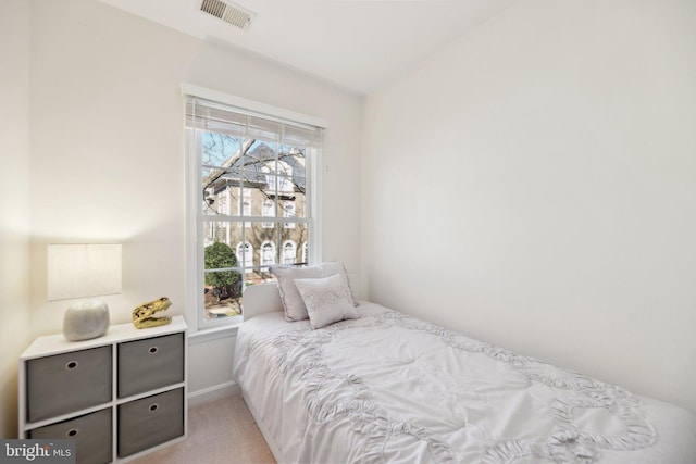 bedroom with light carpet and visible vents