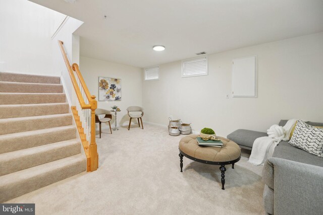 living room featuring visible vents, baseboards, carpet, and stairway