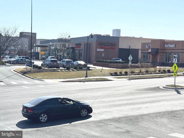 view of road featuring curbs, traffic signs, and sidewalks