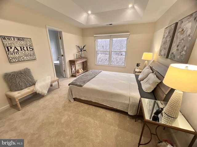 bedroom featuring carpet, visible vents, a tray ceiling, recessed lighting, and connected bathroom